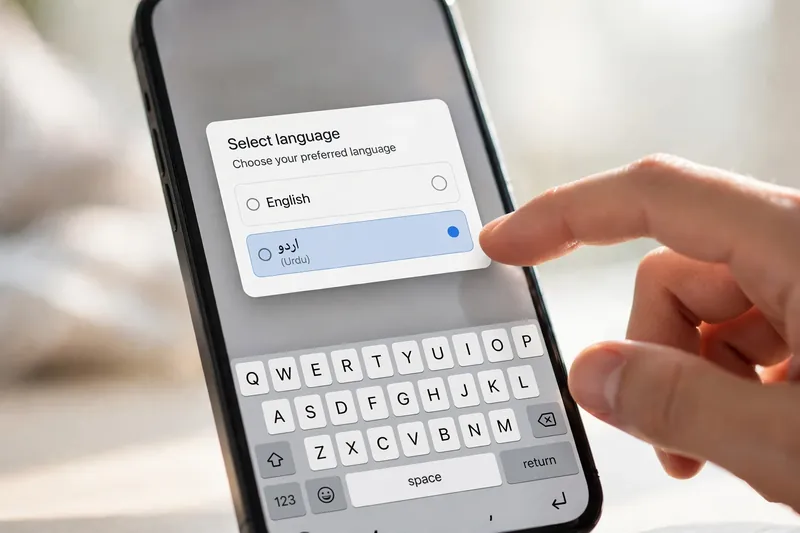 Phone showing a language switcher with Urdu and English options