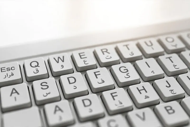 Close-up of physical Urdu keyboard for PC with Urdu and Latin key labels